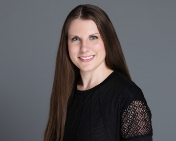 Ashley Ketchum, accounting professional, exuding confidence in a stylish black top and elegant lace sleeves.