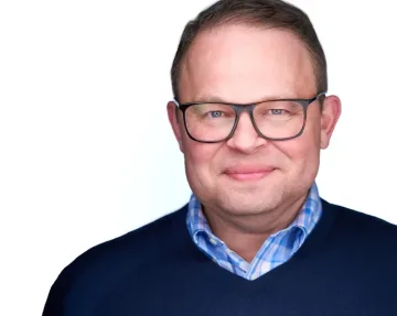 Professional headshot of a male business executive wearing glasses and business casual attire, suitable for foodservice industry leadership.