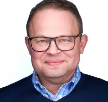 Professional headshot of a male business executive wearing glasses and business casual attire, suitable for foodservice industry leadership.