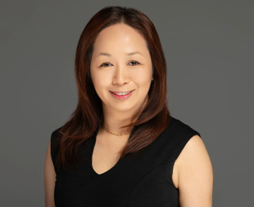 Professional portrait of a woman from Legacy Food Group, showcasing warmth and approachability.